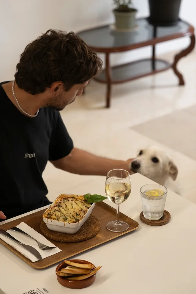 Customer with lasagne and his dog