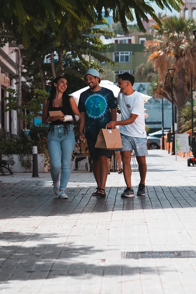 Friends walking with takeaway bags
